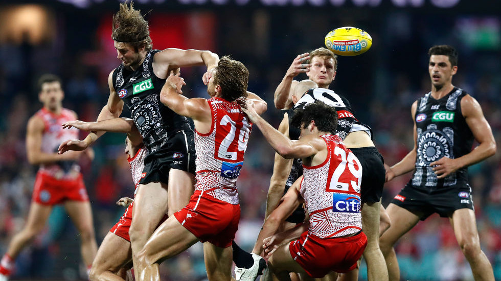 Pies prevail over Swans in a matter of centimetres